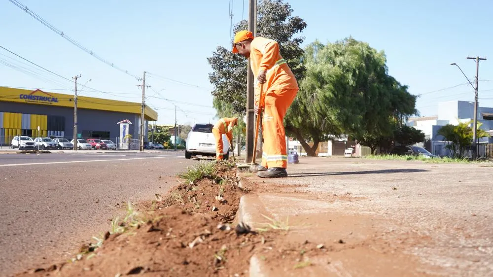 Operários removem o excesso de terra e resíduos acumulados no interior de uma boca de lobo na região central de Cascavel.